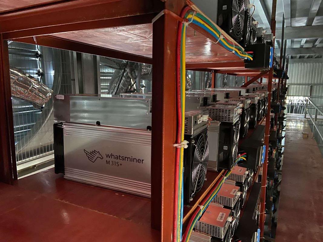 A crypto miner examining a mining rig.