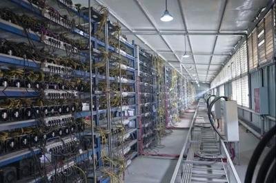 A modern Bitcoin mining farm with rows of mining rigs
